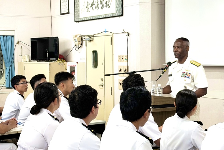 A man at a podium speaking to a group of people