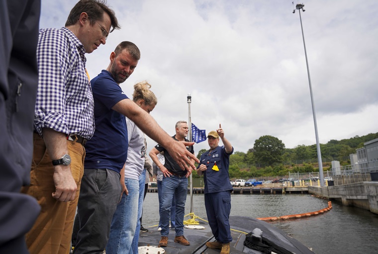 Fire Control Technician 1st Class Alan McLean, escorts faculty and staff assigned to the Newport, Rhode Island,-based U.S. Naval War College (NWC) aboard the Virginia-class fast-attack submarine USS Delaware (SSN 791) at Naval Submarine Base New London, Connecticut, Aug. 1, 2025.