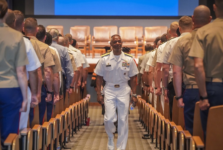U.S. Naval War College (NWC) President Rear Adm. Darryl Walker departs Spruance Hall following the institution's annual Convocation event, welcoming 447 students from all six branches of the U.S. armed forces, U.S. federal government agencies and 42 partner and allied nations, on Tuesday, Aug. 5, 2025.