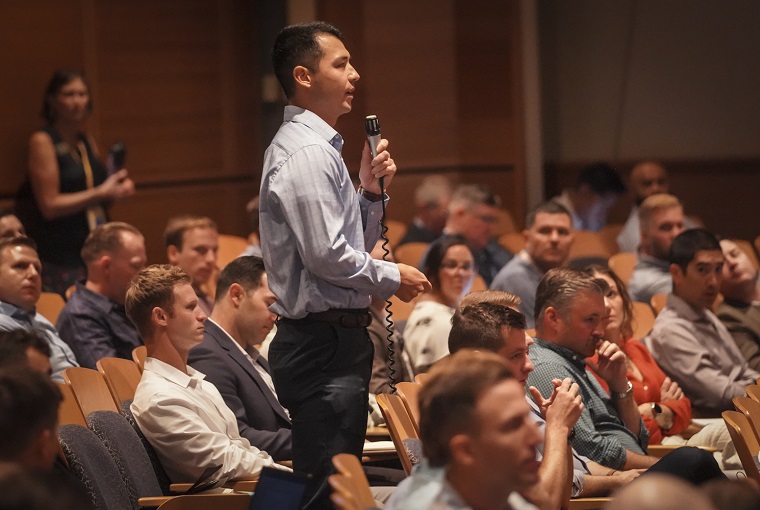 U.S. Navy Lt. Valentine Vena, U.S. Naval War College (NWC) student, asks a question to Max Brooks, author of “World War Z: An Oral History of the Zombie War,” during the Future Warfighting Symposium (FWS) during a tour onboard Delaware onboard Naval Station Newport, Aug. 6, 2025.