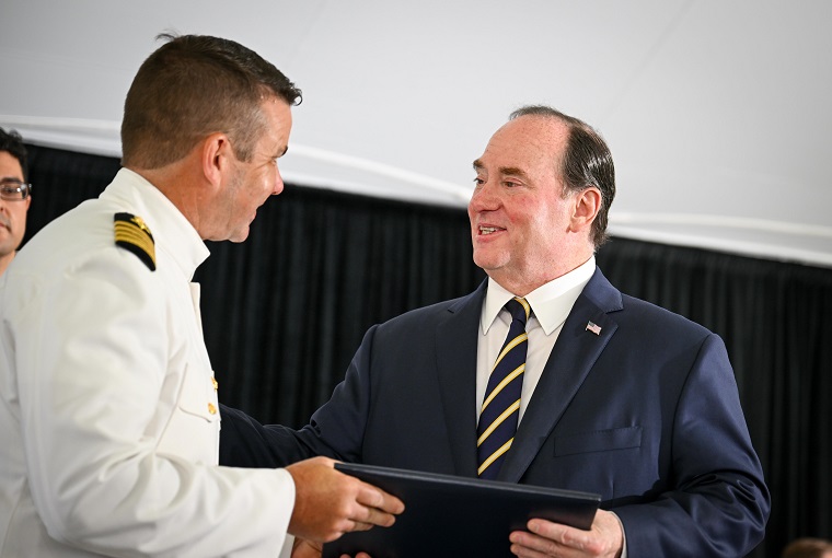 Secretary of the Navy John C. Phelan giving out diplomas at the U.S. Naval War College graduation