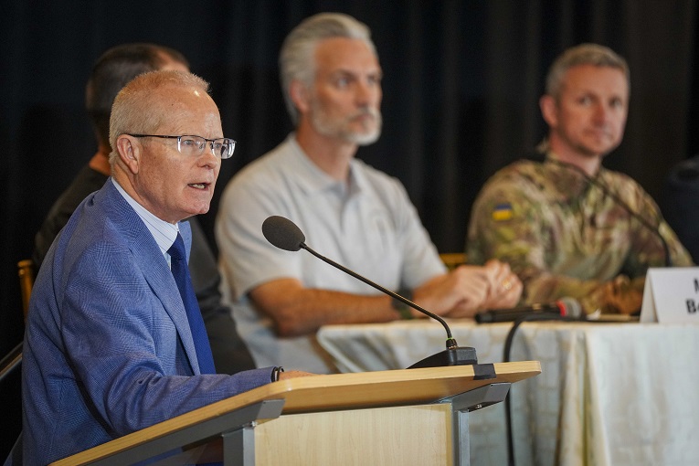 A man speaking at a microphone