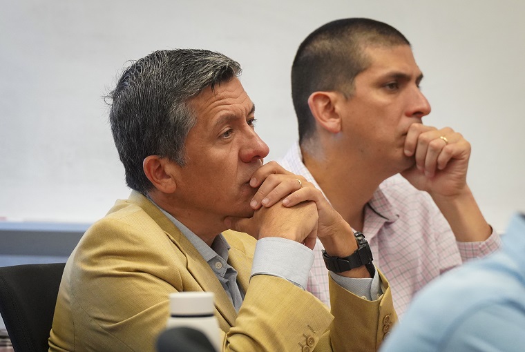 Two people listening at a conference
