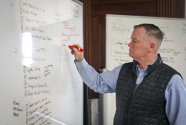 A man writing on a whiteboard