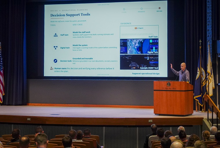 A man speaking at a podium to an auditorium