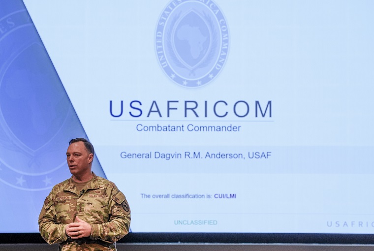 A man in front of a powerpoint slide