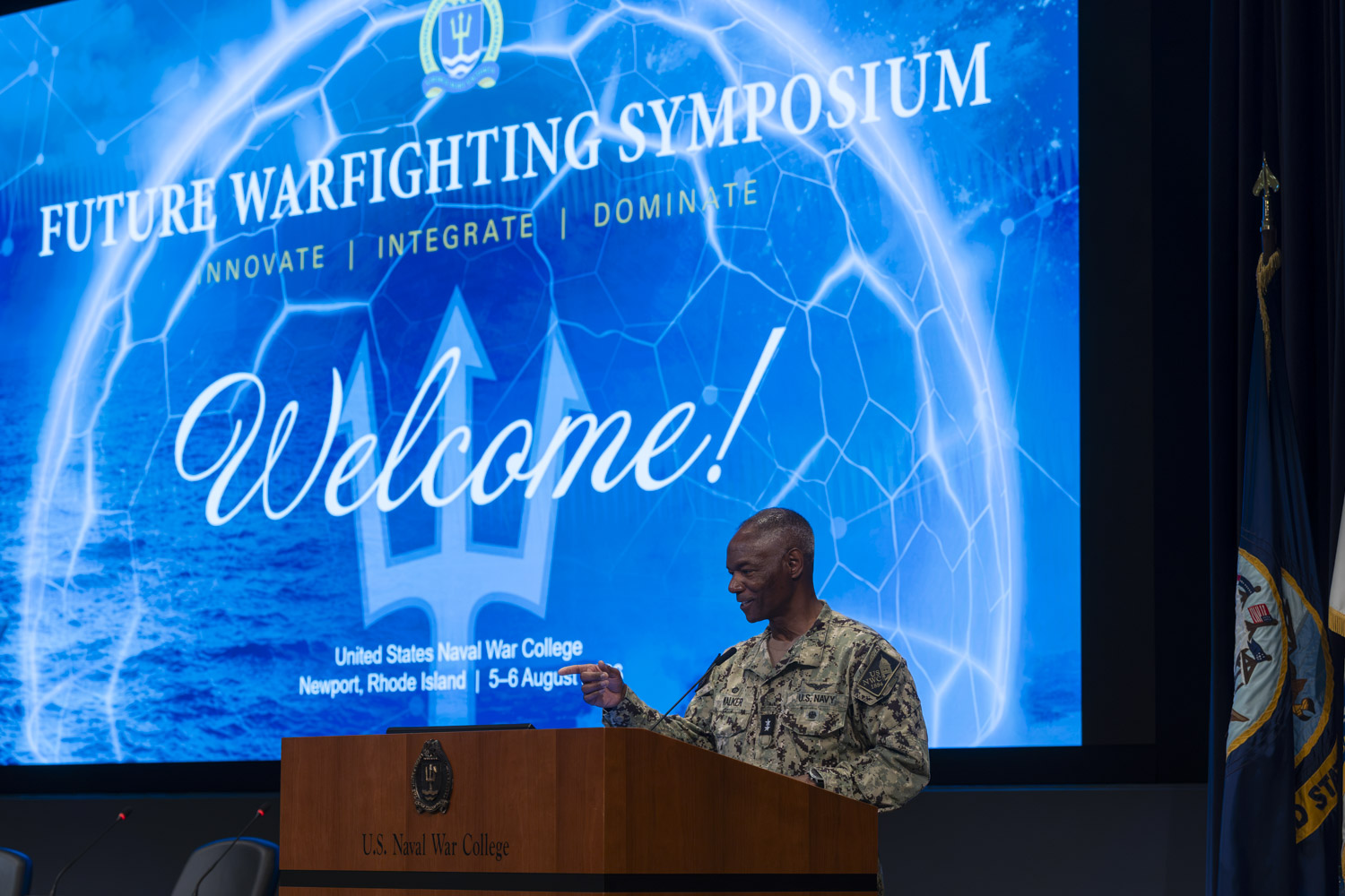 Rear Adm. Darryl Walker, NWC president, speaks at a podium