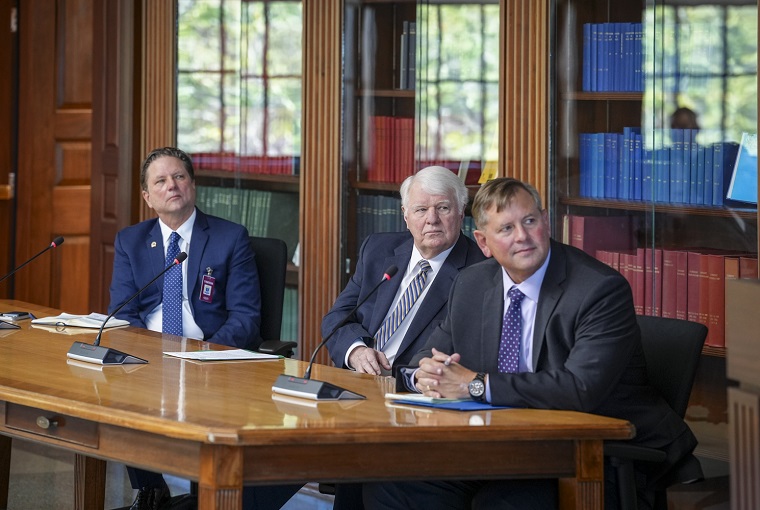 Three men sitting at a table