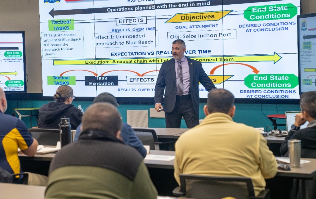 Defense Advanced Research Projects Agency (DARPA) Director Stephen Winchell addresses graduates, faculty and leadership from the U.S. Naval War College (NWC) and Naval Postgraduate School (NPS).
