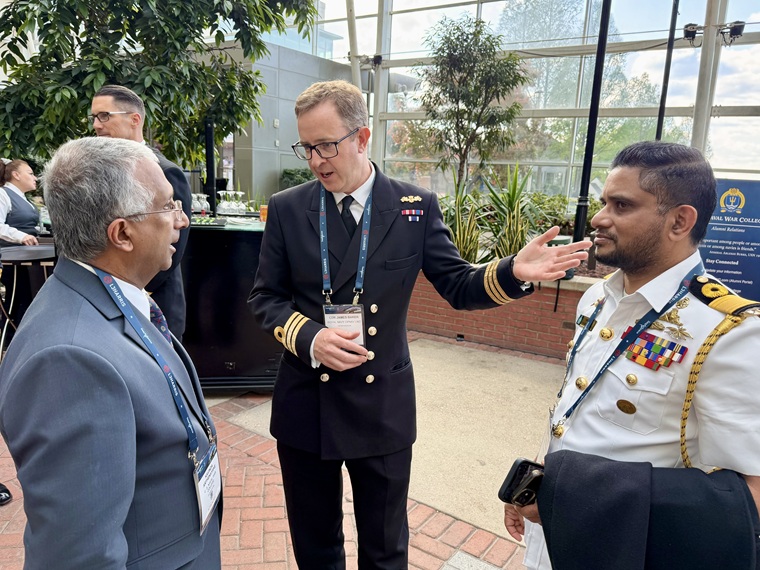 Kavinda Arthenayake, director of alumni relations at the U.S. Naval War College (NWC), left, speaks to Cmdr. James Barker of the Royal Navy, center, and Commodore Dumindu Abeywickrama of the Sri Lanka Navy, right, at an alumni event co-hosted by the NWC and Naval Postgraduate School during the Navy League of the United States' Sea-Air-Space Expo in National Harbor, Maryland, on April 20, 2026.