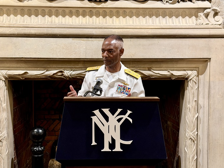 Rear Adm. Walker speaking at a podium
