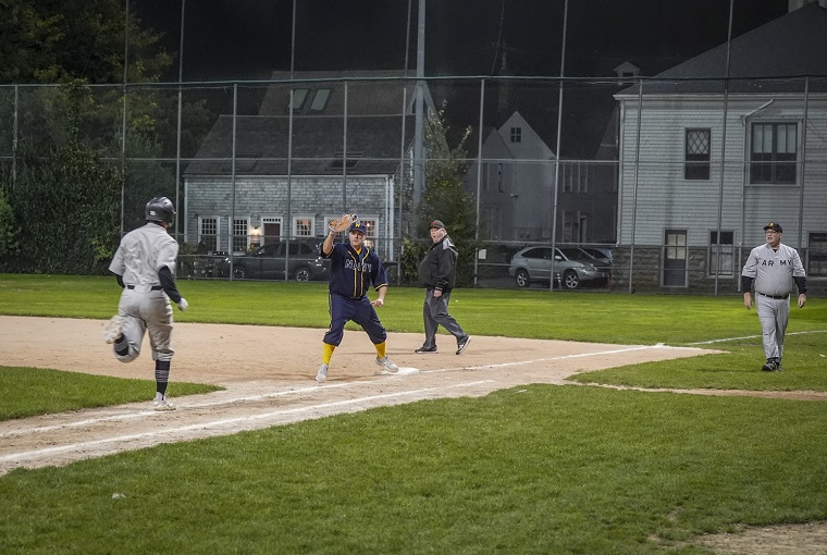 A baseball player running to a base