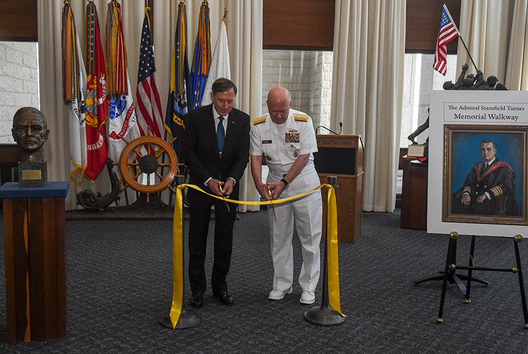 Rear Adm. Jeffrey Harley cutting rope to the new Stansfield Turner Memorial Walkway