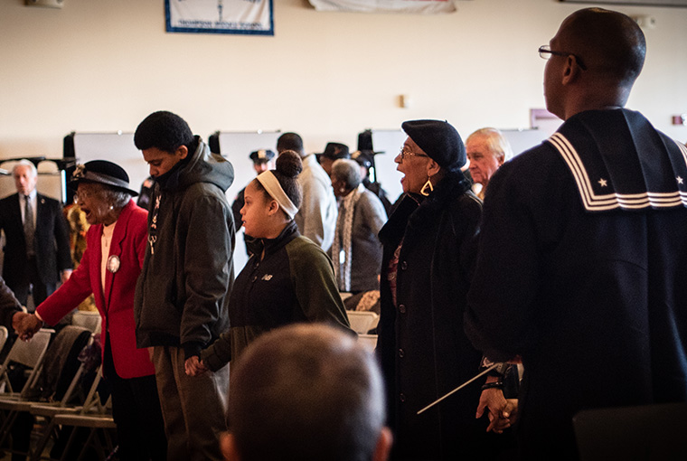 Musician 1st Class Phillip Martin, unit leader for Navy Band Northeast’s ceremonial band, reflects on the crowd gathered to celebrate the life and legacy Martin Luther King Jr. at Thompson Middle School, Newport, Rhode Island.