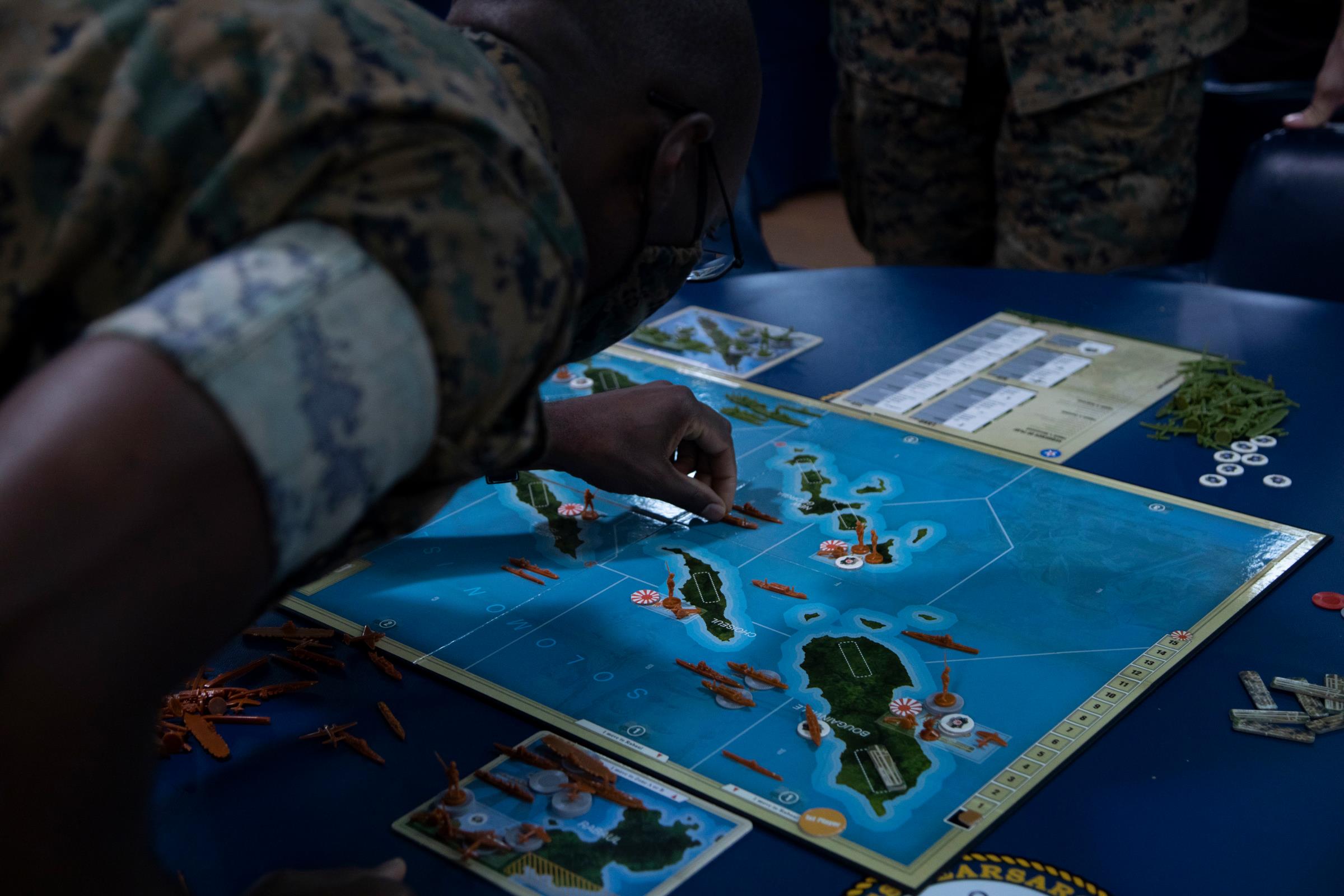 ATLANTIC OCEAN (Oct. 22, 2021) U.S. Marine Corps officers assigned to the 22nd Marine Expeditionary Unit (MEU) conduct a wargaming scenario aboard the amphibious assault Ship USS Kearsarge (LHD 3), Oct. 22, 2021. The wargame was an exercise used by the Marine officers to increase proficiency in real-time decision making during PHIBRON-MEU Integrated Training (PMINT). PMINT is the first at-sea period in the MEU�s Pre-deployment Training Program; it aims to increase interoperability and build relationships between Marines and Sailors. (U.S. Marine Corps photo by Cpl. Yvonna Guyette)
