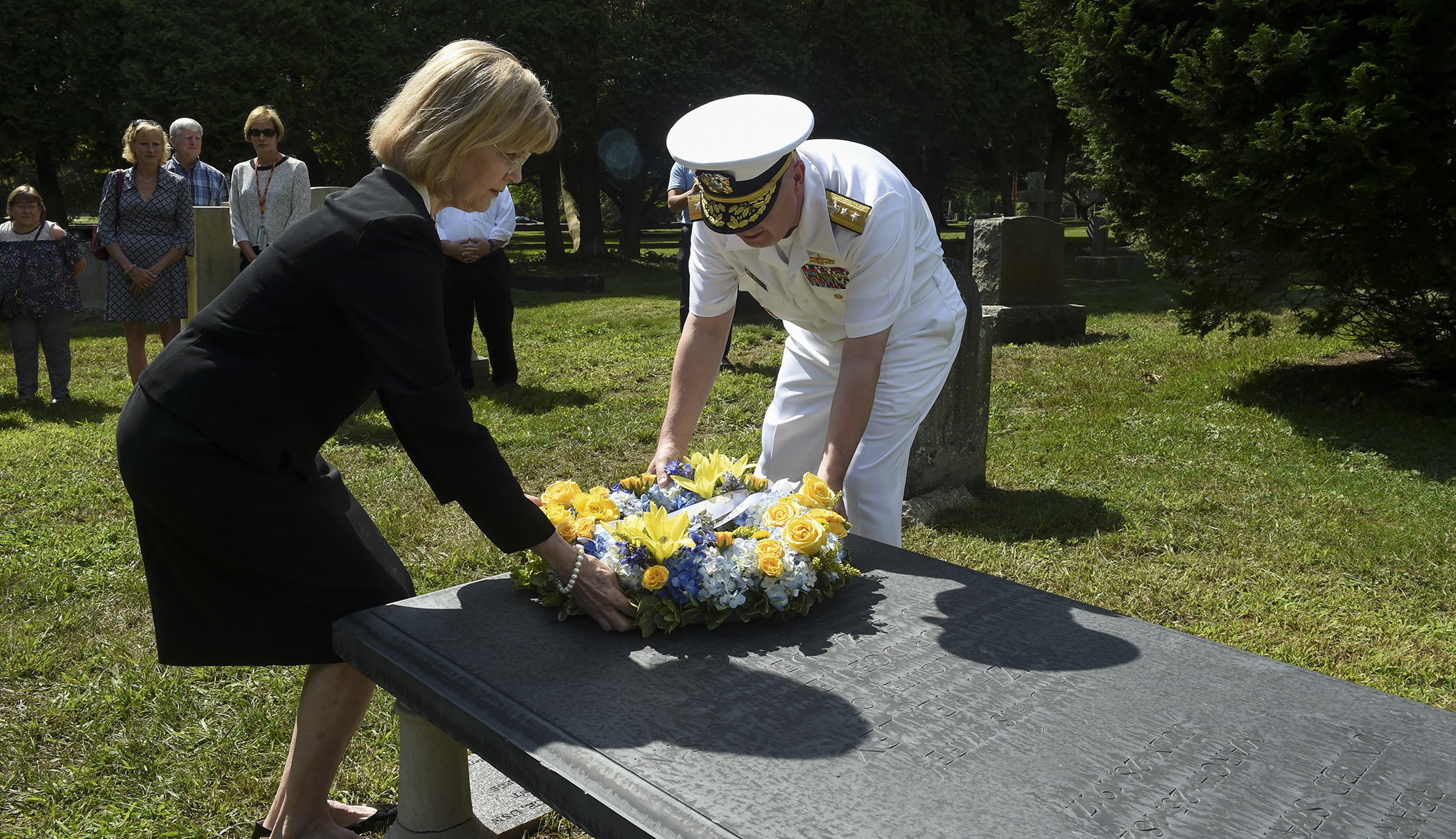 Anne Dubose Joslin, great, great grandniece of Rear Adm. Stephen B. Luce, and Rear Adm. Jeffrey A. Harley, president, U.S. Naval War College (NWC), place a wreath donated on Luce’s gravestone during a during a commemoration ceremony at St. Mary’s Episcopal Church Cemetery to mark the 100th anniversary of Luce’s death. Luce was the founder of NWC and served as its president from Oct. 6, 1884 until June 22, 1888.