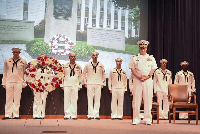 Rear Adm. Jeffrey A. Harley, president, U.S. Naval War College (NWC) bows his head during the closing remarks following a wreath laying at a ceremony to commemorate the 17th anniversary of the 9/11 attacks