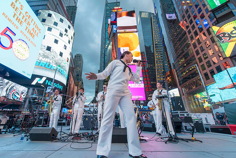 Musician Third Class Cristiana Villalva sings with Navy Band Northeast's Rock Band, Rhode Island Sound in Times Square during Fleet Week New York, 2017.