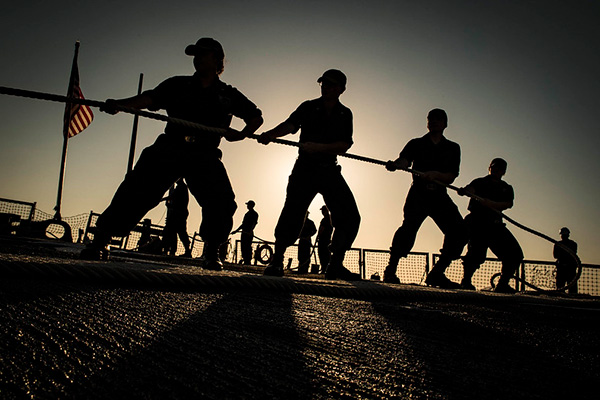 Sailors heave mooring line aboard the Arleigh Burke-class guided-missile destroyer USS Carney (DDG 64) as the ship arrives in Valencia, Spain, Sept. 21, 2018.
