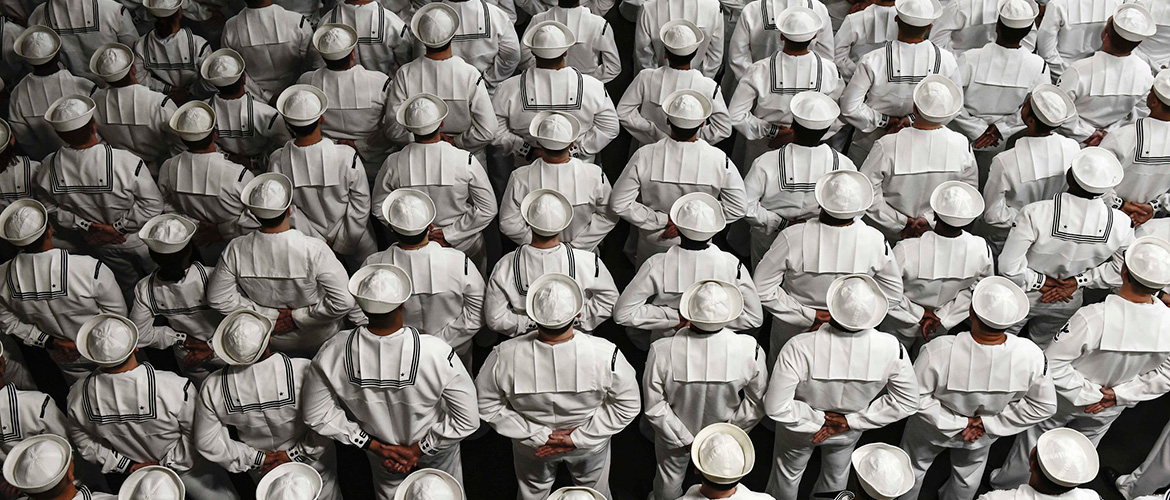 Sailors stand at parade rest during a change of command ceremony aboard the amphibious assault ship USS Wasp.