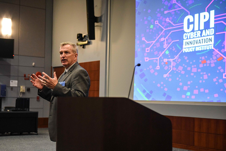 Rear Adm. Pete Brown, U.S. Coast Guard National Security Council, gives opening remarks for the Defend Forward: 2019 Critical Infrastructure War Game at the U.S. Naval War College, July 25, 2019. 