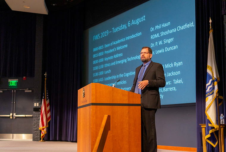 Phil M. Haun, dean of academics, U.S. Naval War College (NWC), provides opening remarks at the Future Warfighting Symposium in NWC’s Spruance Auditorium, Aug. 6.