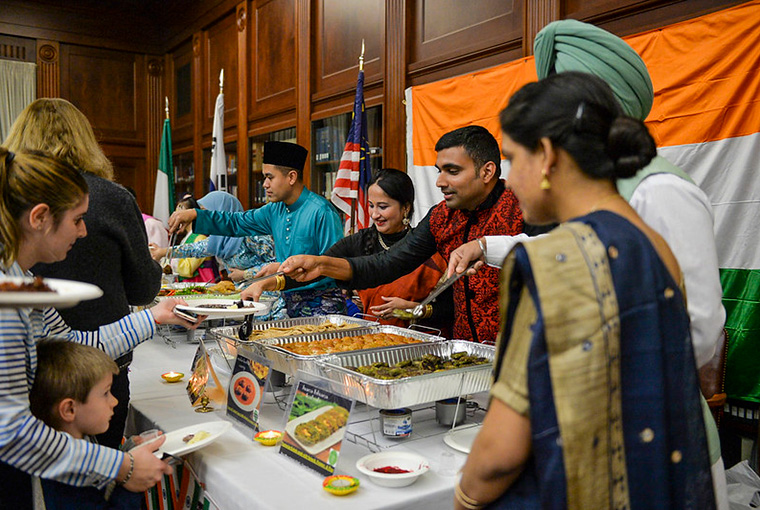 Lt. Cmdr. Swapnil Srivastava of the Indian Navy and Commandant j.g. Samar Singh Sandhu of the Indian Coast Guard and their families present examples of Indian cuisine at the Jan. 24 International Cuisine Night at the U.S. Naval War College.