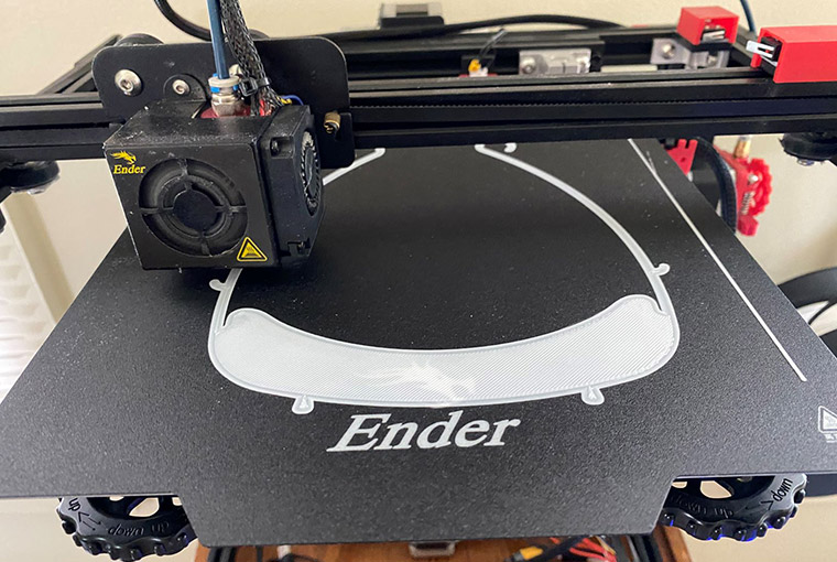 3D-printer printing face shields as protective equipment in the medical community.