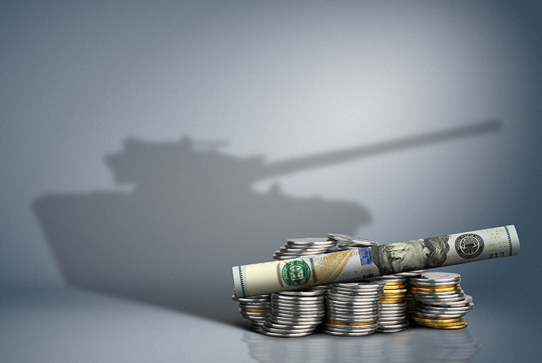 Money arranged so the shadow looks like a military tank.