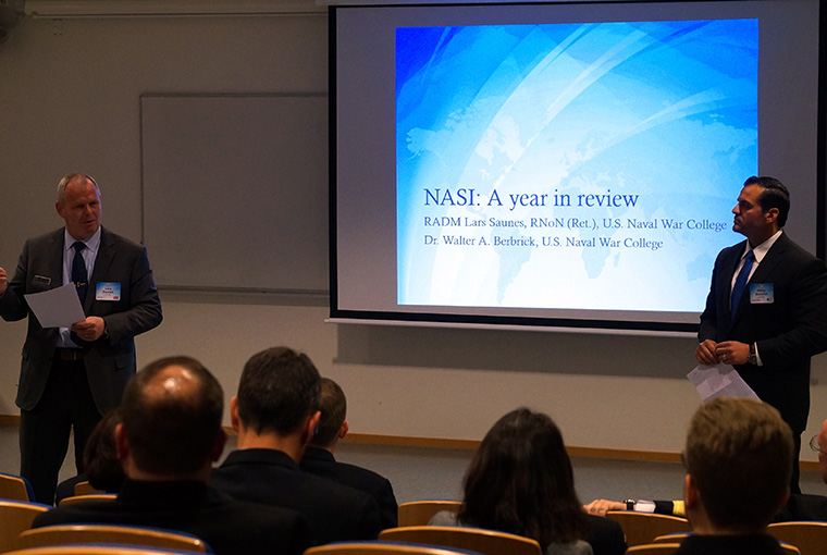 Professors Lars Saunes (left), former chief of Royal Norwegian Navy and Walter Berbrick (right), co-lead scholars for the Newport Arctic Scholars Initiative discuss important arctic issues at the final NASI symposium held in Bergen, Norway, April 8-9, 2019. 