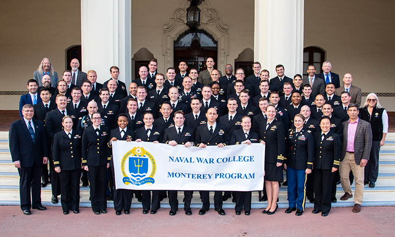 NPS students participating in the Naval War College’s Office of Distance Education program pose for their graduating cohort portrait, following the certificate presentation in Herrmann Hall’s McNitt Ballroom, Dec. 12.