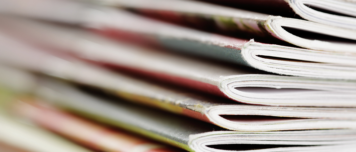 Reports on a desk stacked up