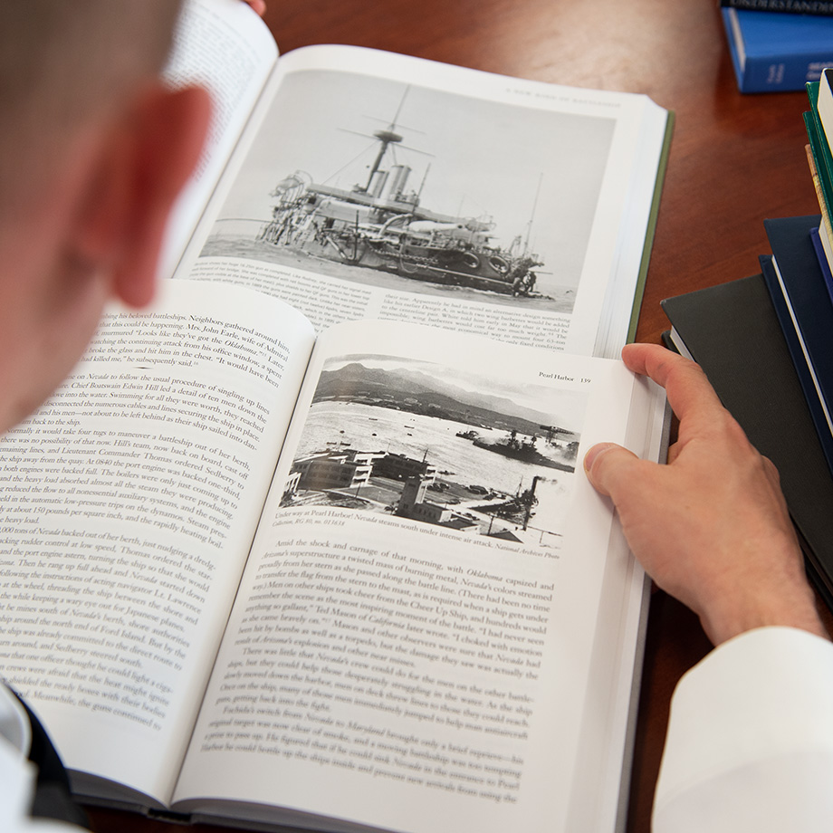 Student reading a book at the U.S. Naval War College.