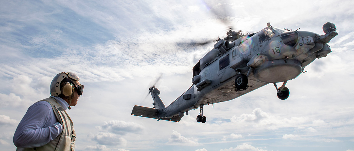 Chief Boatswain’s Mate William Garcia, from Los Angeles, serves as the flight deck safety observer as an MH-60 Sea Hawk helicopter assigned to the Scorpions of Helicopter Maritime Strike Squadron (HSM) 49, takes off from the flight deck of the Arleigh Burke-class guided-missile destroyer USS Milius (DDG 69).