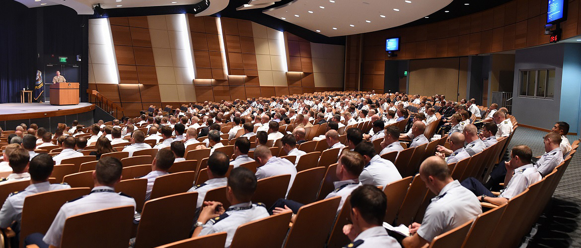 More than 300 new Navy, Army, Air Force, Coast Guard and Marine Corps students listen to an orientation briefing at U.S. Naval War College at Naval Station Newport, Rhode Island.