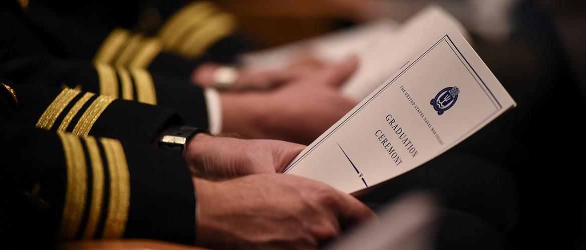 A U.S. Naval War College (NWC) student holds a program during his graduation ceremony held at NWC’s Spruance Auditorium. 