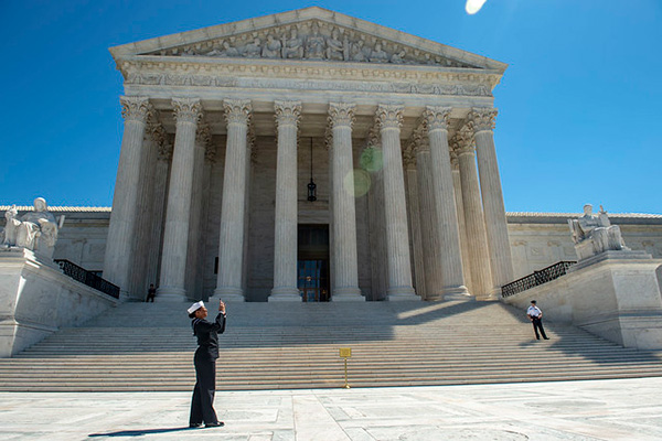 Personnel Specialist 1st Class Angelita Baggoo, a finalist for Navy Reserve Sailor of the Year, takes a photograph outside the Supreme Court building during a tour of the capital region.
