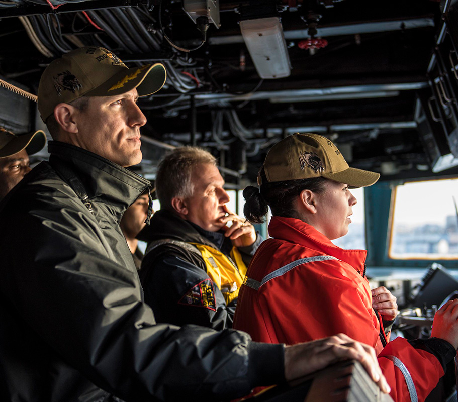 Cmdr. Craig Trent, left, commanding officer of the Arleigh Burke-class guided-missile destroyer USS Porter (DDG 78), observes from the bridge as the ship departs Plymouth, England, Feb. 11, 2019.