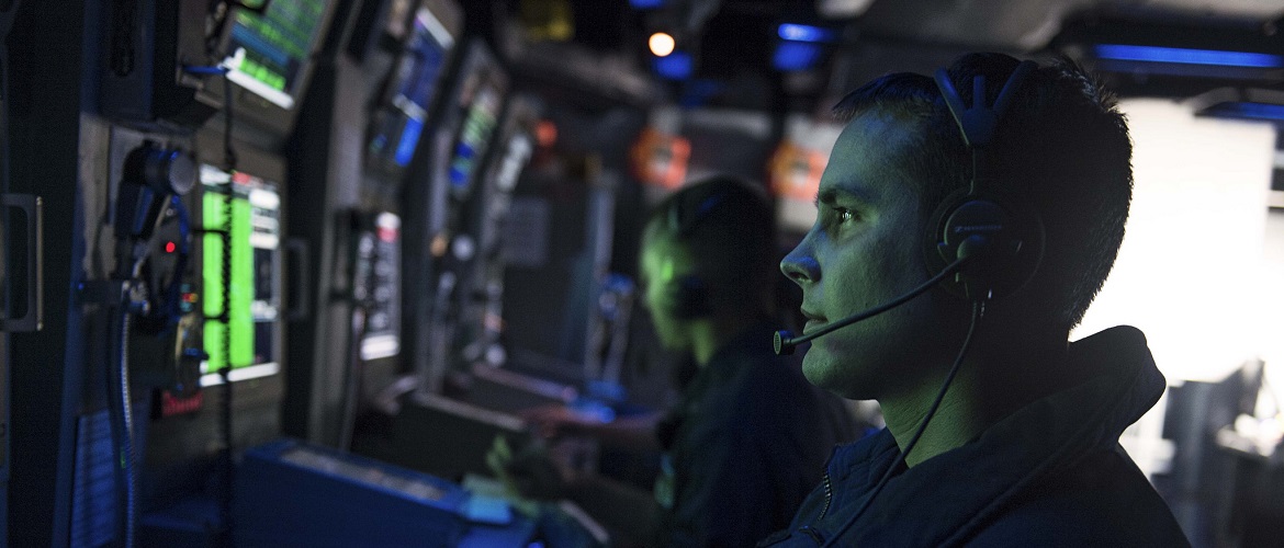 Sonar Technician (Surface) 3rd Class Michael E. Dysthe stands watch in the combat information center during a anti-submarine warfare exercise aboard the Ticonderoga-class guided-missile cruiser USS Chancellorsville (CG 62).